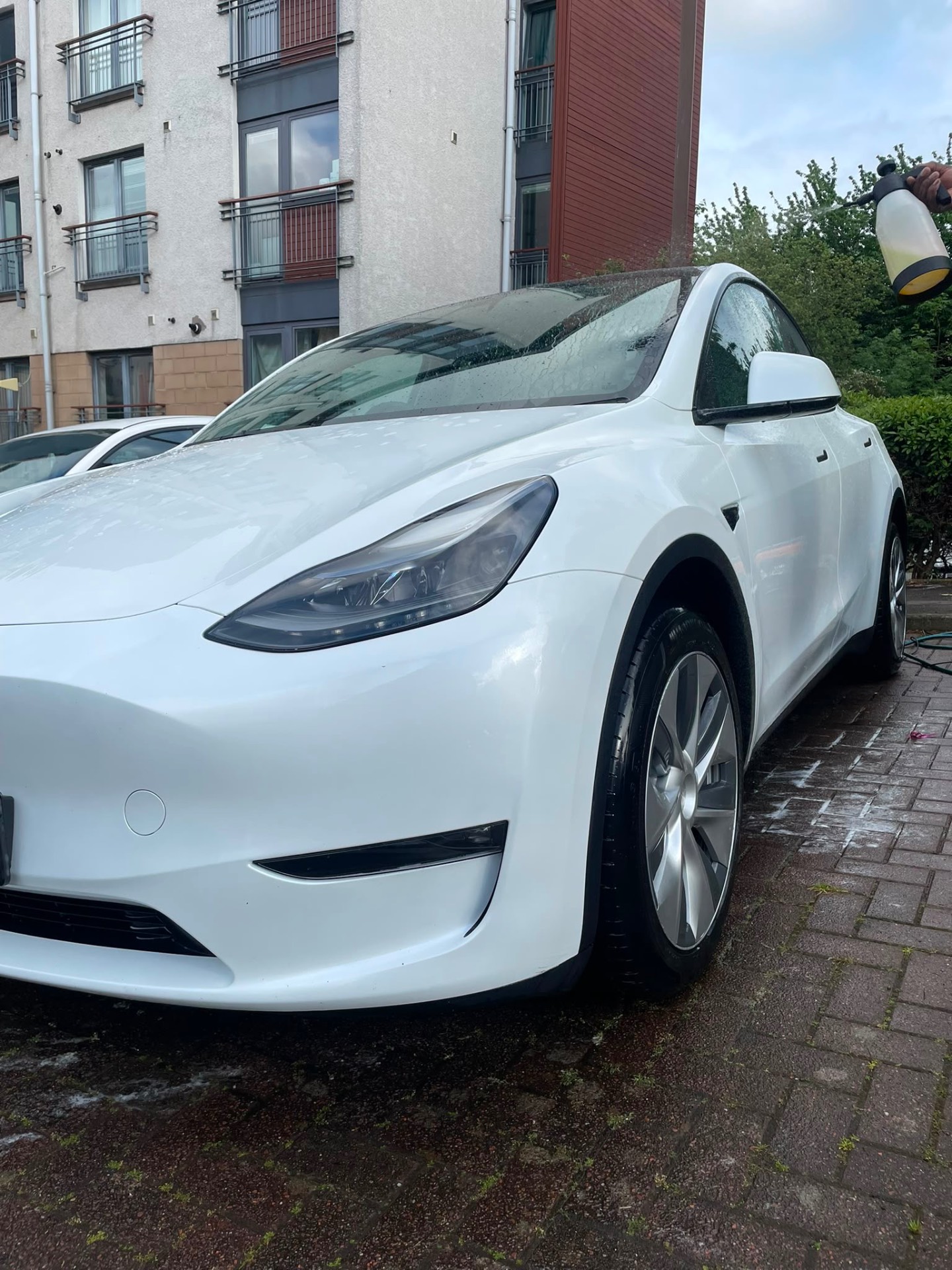 White Tesla during an M&M Deluxe snow foam wash